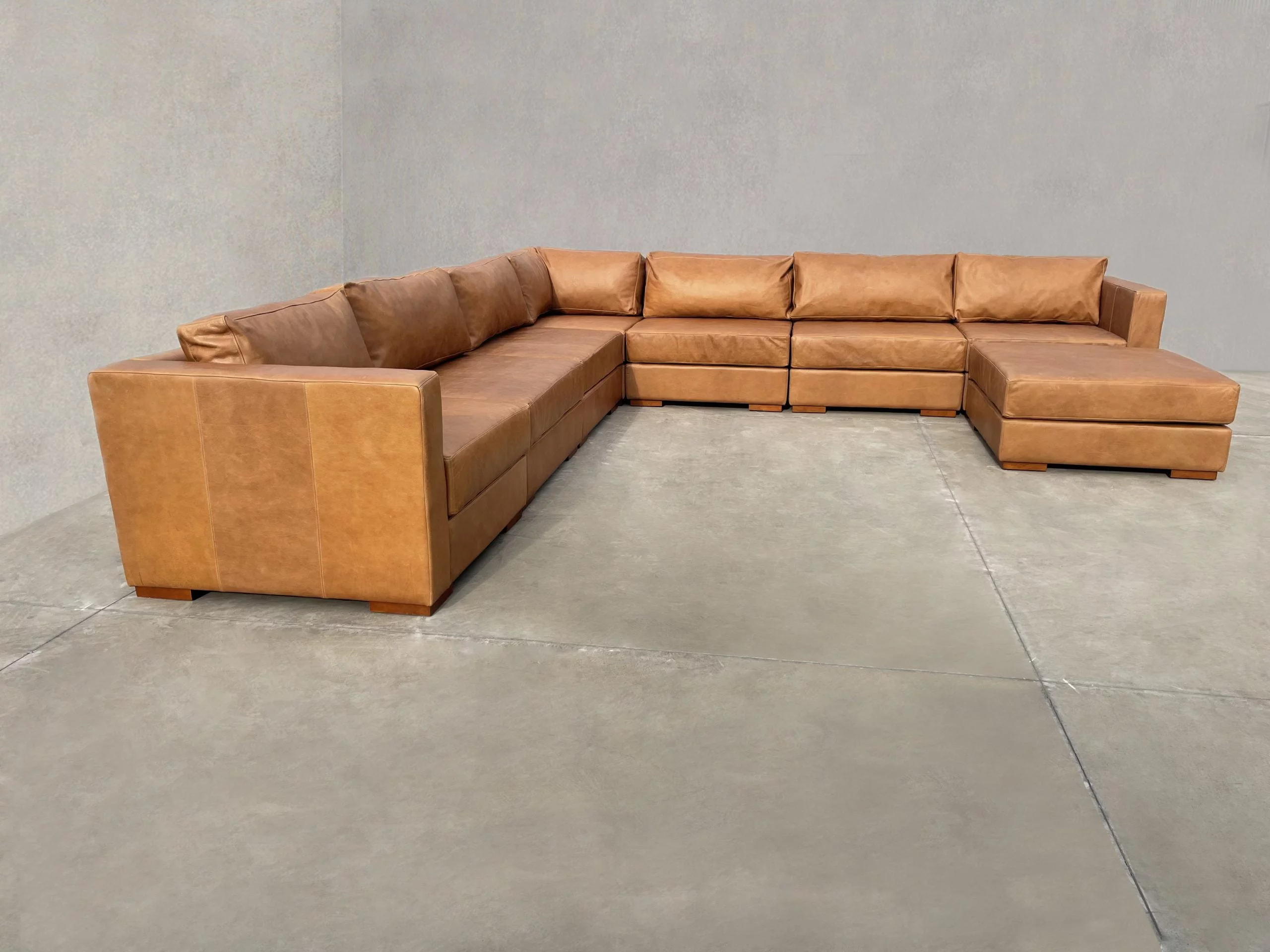 Modular Symphony en L, 7 módulos + 1 pouf, Color Fargo Tan, Asiento Liso, con apoyabrazos, Cuero 100% Natural Uruguayo